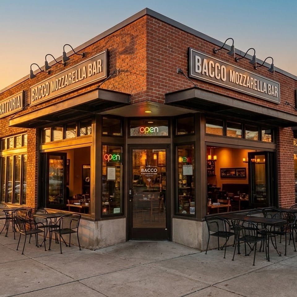 Bacco Mozzarella Bar, a brick trattoria with outdoor seating, at sunset.